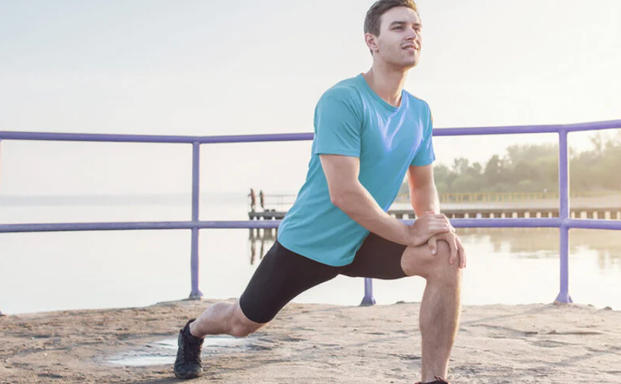 Person stretching outdoors with overlay text showing 5 physio tips to prevent sports injuries