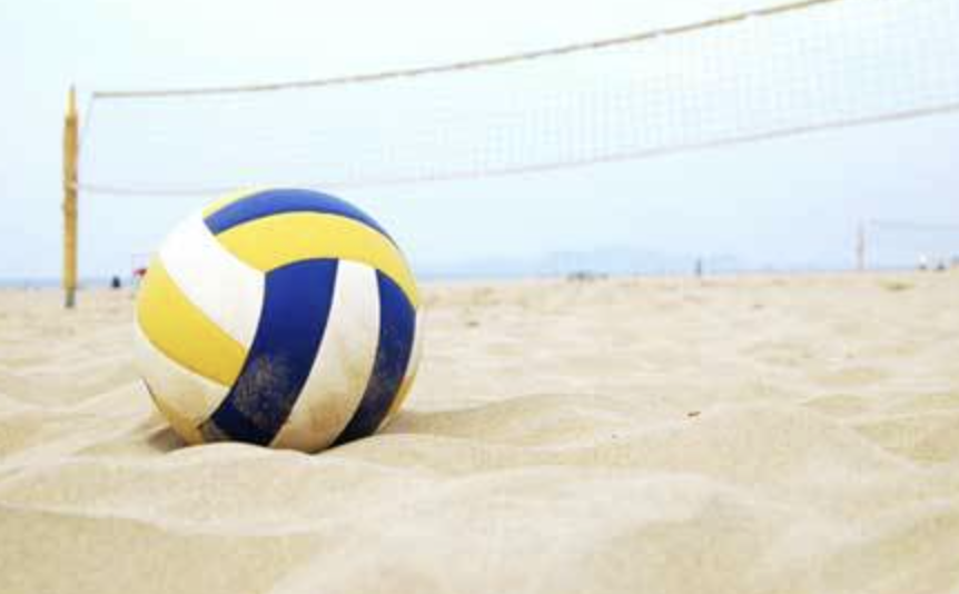 Beach volleyball scene with net and ball, symbolizing active summer sports